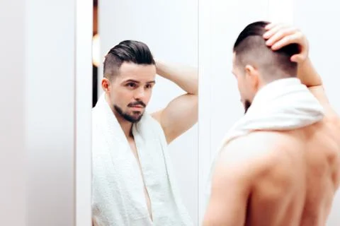 Handsome Man Checking Himself in the Mirror Foto stock