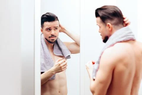 Handsome Man Checking Himself in the Mirror Stock Photos