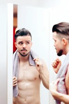 Handsome Man Checking Himself in the Mirror Stock Photos