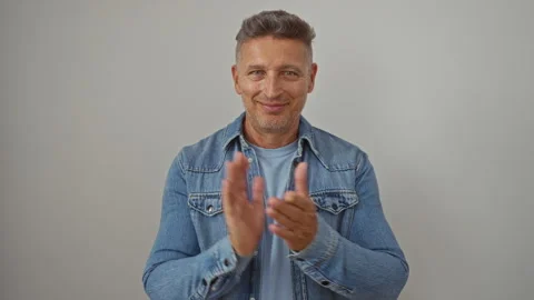 Handsome man clapping in denim jacket over isolated white background, showc.. Stock Footage 283549767
