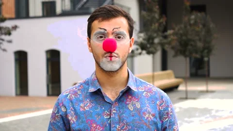 Handsome man clown looking at camera outdoor Stock Footage 137426791