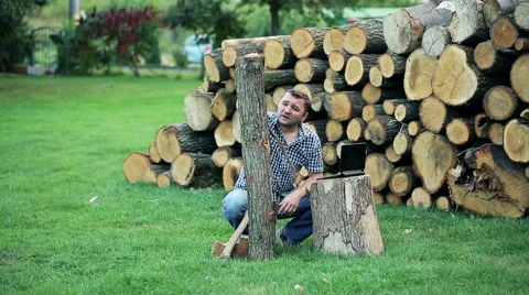 Handsome man comparing stump size with data in laptop in the garden Stock Footage 58859018