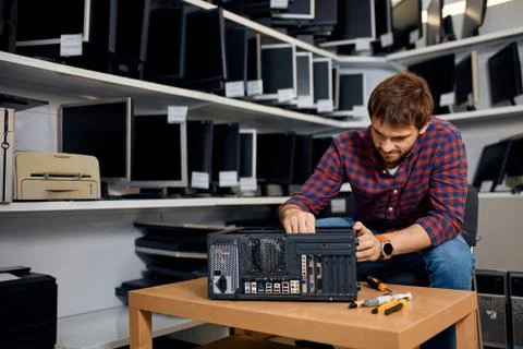 Handsome man concentrated on repairing a computer Stock Photos