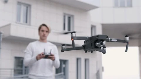 Handsome man controlling flying drone. Stock Footage 106190503