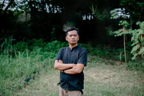A handsome man in a cool pose is looking at the camera Stock Photos