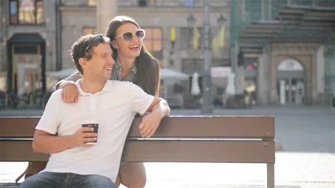 Handsome Man with Cup of Coffee in Hand Sitting on the Bench on the City Square Stock Footage 86513112