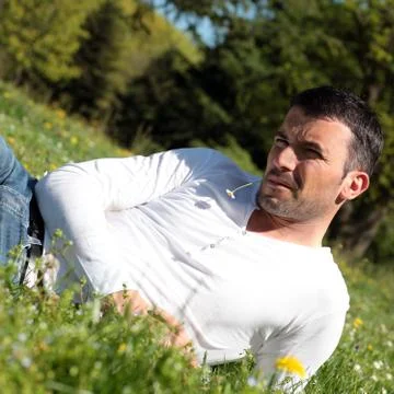 Handsome man with daisy Stock Photos