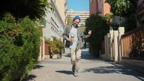 Handsome man dancing and smiling while listening his favorite song and enjoying Stock Footage 108435971