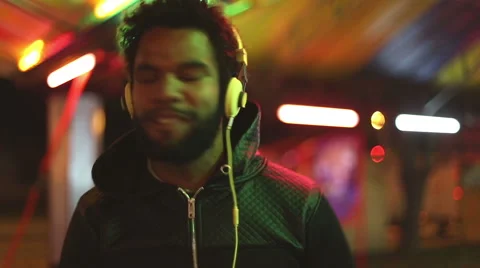 Handsome man dancing to the rhythm of music with headphones Stock Footage 59556078