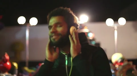 Handsome man dancing to the rhythm of music with headphones Stock Footage 59556127
