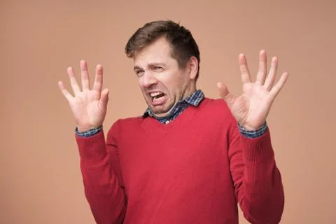 Handsome man demonstrates refusal gesture, asks not bother him, rejects somet Stock Photos