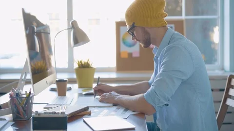 Handsome man, designer working in creative agency office Stock Footage 123916357