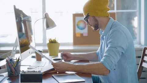 Handsome man, designer working in creative agency office Stock Footage 123916358