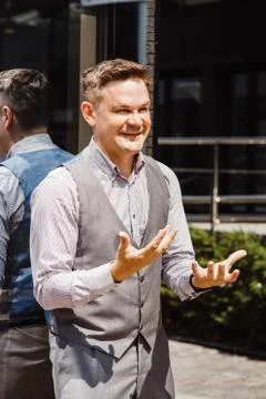 Handsome man discussing. Man on cityscape and buildings with reflections of city Stock Photos