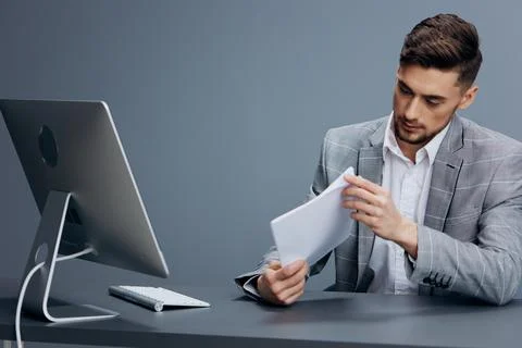 Handsome man documents on the table computer work emotions technologies Stock Photos