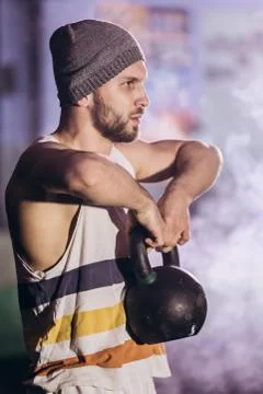 Handsome man doing exercise with dumbbells. Stock Photos