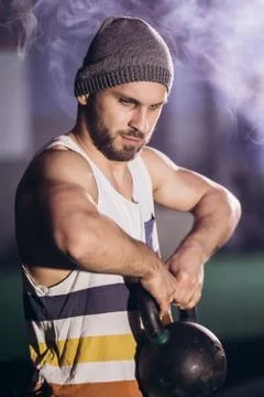 Handsome man doing exercise with dumbbells. Stock Photos