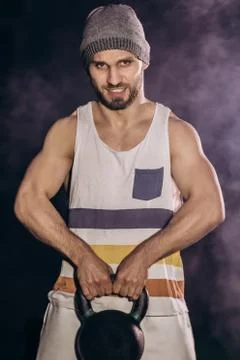Handsome man doing exercise with dumbbells. Stock Photos