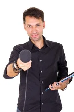 Handsome man doing interview with notes and microphone Stock Photos