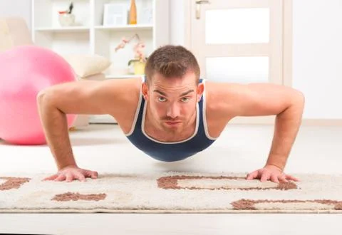 Handsome man doing push ups Stock Photos