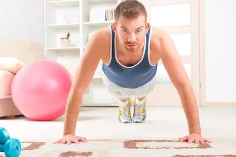 Handsome man doing push ups Stock Photos