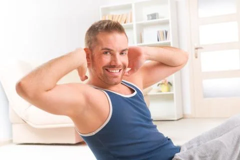 Handsome man doing sit ups Stock Photos