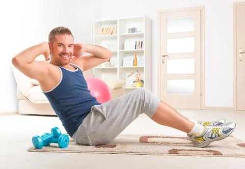 Handsome man doing sit ups Stock Photos