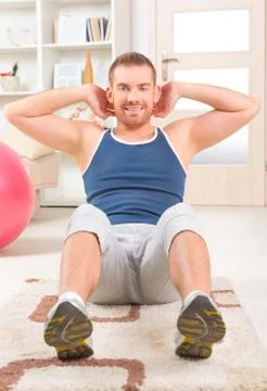 Handsome man doing sit ups Stock Photos