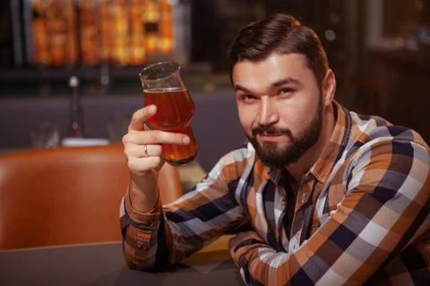 Handsome man drinking beer at the pub Stock-Fotos