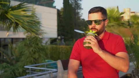 Handsome man drinking a cocktail Stock Footage 133002587