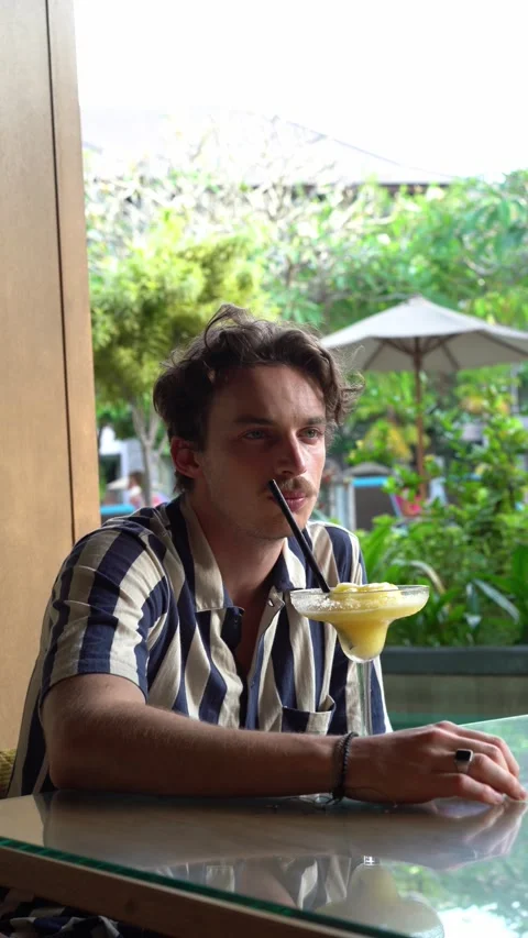 Handsome man drinking cocktail Video stock 218038610