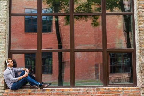 Handsome man drinking coffee outside of office building Stock Photos