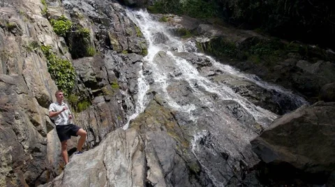 Handsome Man Drinking Fresh Water by Waterfall. Slow Motion Stock-Footage 49110697