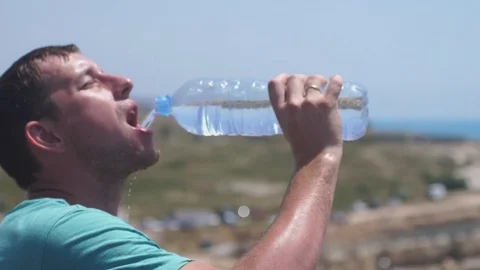 Handsome man drinking water during break in running, slow motion. 3840x2160 Stock Footage 84599003