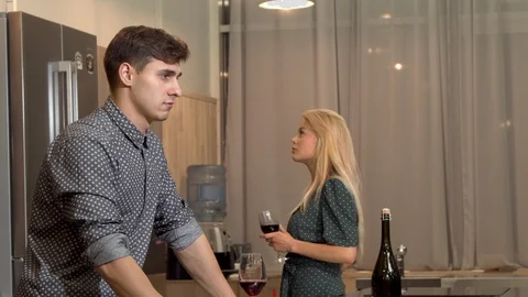 Handsome man drinking wine after having a fight with his girlfriend at home Stock Footage 102897235