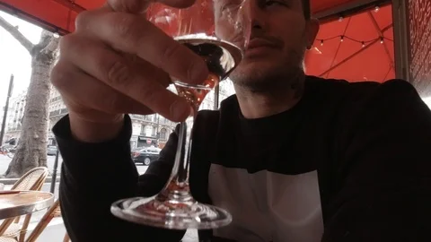 Handsome man drinking wine in a cafe in Paris Stock Footage 126644519
