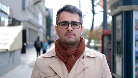 A handsome man of Eastern appearance, looks at the camera. Slow motion Stock Footage 142509114