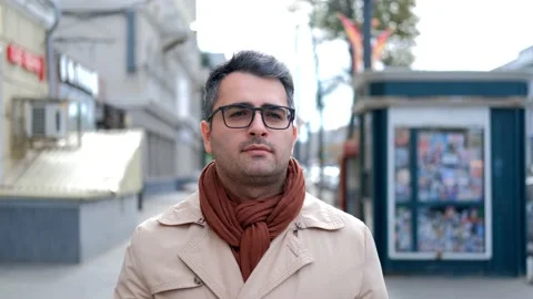 The handsome man of Eastern appearance, walks down the street Stock Footage 142350730