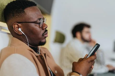 Handsome man educating himself while watching an online tutorial before he keeps Fotos Stock