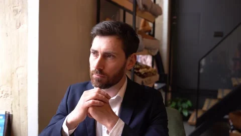 Handsome man in elegant style nodding with head while sitting in cafe. Agreeing Stock Footage 188473262
