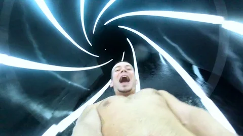 Handsome man enjoying the waterslide    Stock Footage 69725261