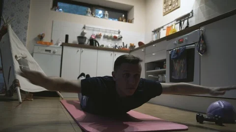 Handsome Man Exercising and Doing Push ups in The Kitchen at Home Vídeos de archivo 107308993