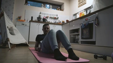 Handsome Man Exercising and Doing Push ups in The Kitchen at Home Stock Footage 107594106