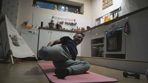 Handsome Man Exercising in The Kitchen at Home Stock Footage 107925250