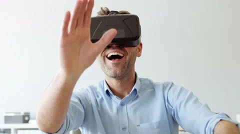 Handsome man experincing virtual reality using VR headset Stock Footage 65303034