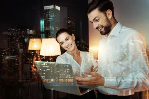 Handsome man explaining the basics to his female colleague Stock Photos