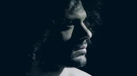 Handsome man feeling pain in the dark slow motion Stock Footage 59473439