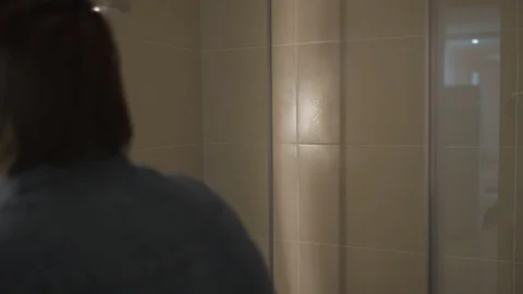 Handsome man fixing beard in front of the bathroom mirror Stock Footage 127648873