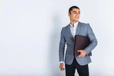 Handsome man with folder man reading a menu, a stylish business guy in suit i Stock Photos