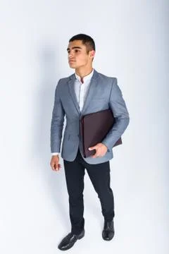 Handsome man with folder man reading a menu, a stylish business guy in suit i Stock Photos